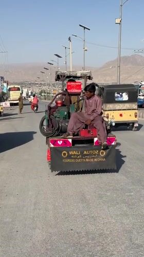 Street life in Quetta with traditional dress and custom vehicles