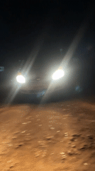 Nighttime vehicle activity captured on dirt road in Bukuru