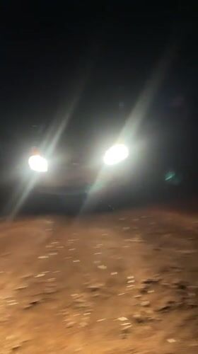 Nighttime vehicle activity captured on dirt road in Bukuru