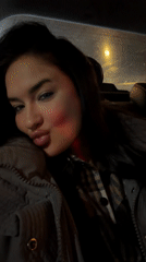 Woman filmed in car under dim lighting in Moscow