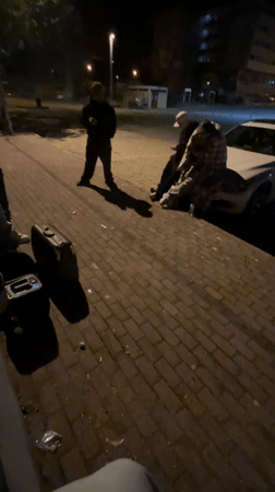 Nighttime gathering observed on sidewalk in Vila Real, Portugal