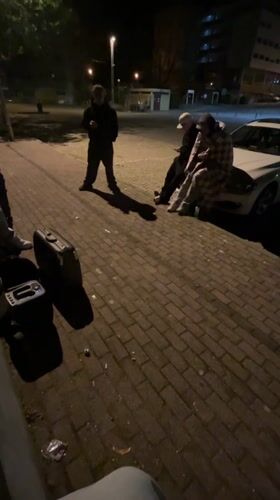 Nighttime gathering observed on sidewalk in Vila Real, Portugal