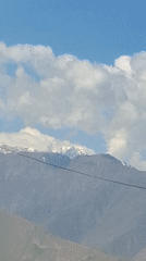 Snow-covered mountains filmed from vehicle in Tajikistan