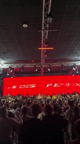Late-night electronic event in Bordeaux, crowd packed around DJ setup