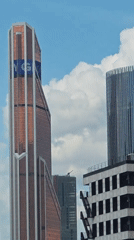 Urban skyline survey: ornate towers, glass buildings, and active construction