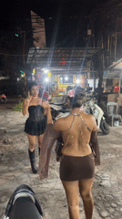 Two women spotted on Denpasar street, one with smartphone