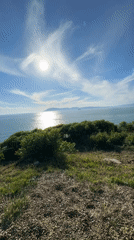 Sunny afternoon coastline documentation in Kabardinka, Russia features ship