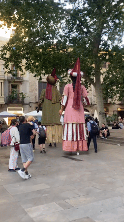 Traditional Catalan giant figures parade through Barcelona streets
