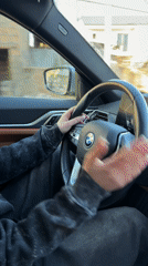 Young woman drives BMW sedan in Agarak, Armenia