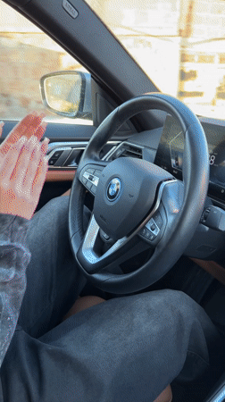 Young woman drives BMW sedan in Agarak, Armenia