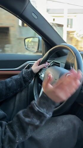 Young woman drives BMW sedan in Agarak, Armenia