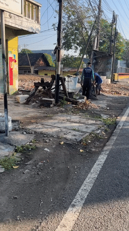 Morning motorcycle traffic moves through Kludan's streets