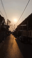 Morning street traffic flows through wet Banjarmasin roads