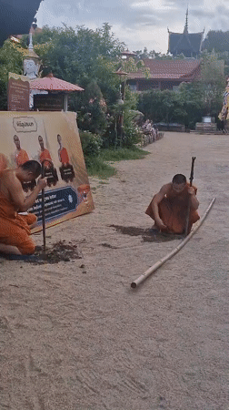 Monks and a gilded Buddha at a temple complex