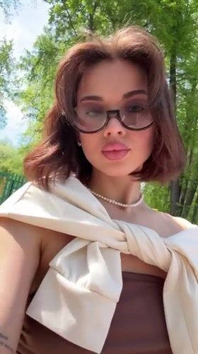 Woman photographs herself at landmarks in Sarapul, Russia