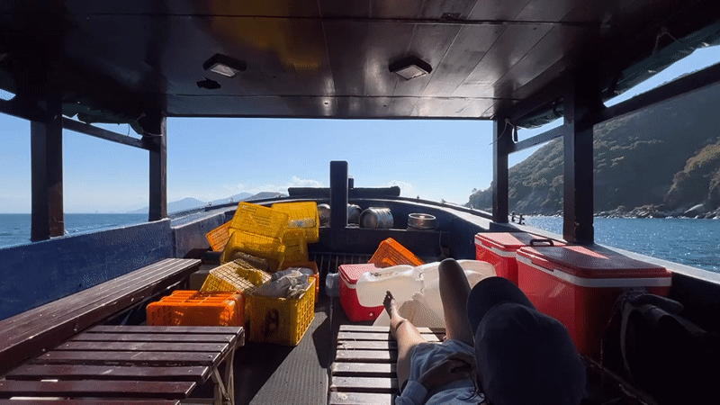Fisher rests aboard working boat near Nha Trang coast