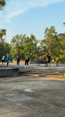 Volleyball game on concrete platform near water in Kathu