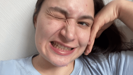 Woman makes playful faces during morning selfie session