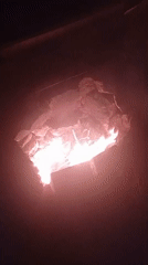 Makeshift fire pit burns at night in Barcelona