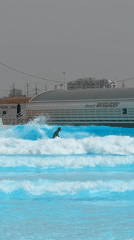 Surfer rides artificial waves at Tel-Aviv wave pool