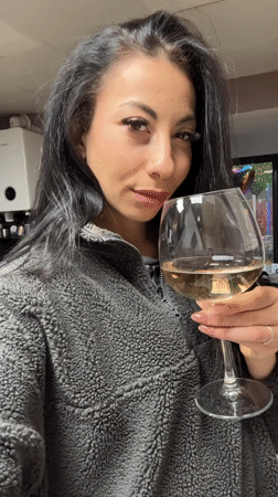 Woman enjoys white wine in Warrington evening