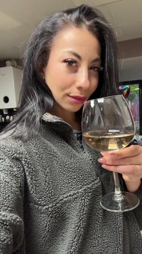 Woman enjoys white wine in Warrington evening