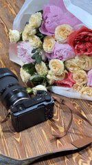 Floral photography session documented with camera and gift arrangements