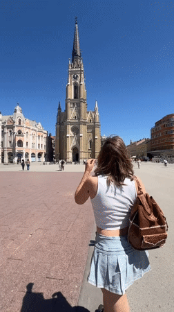 Woman visits Freedom Square cathedral in Novi Sad