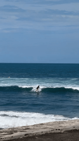 Early morning surfing session captured off Kediri coast
