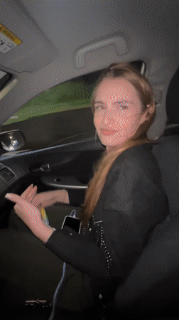 Woman raps in parked car during evening in Budva