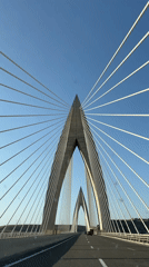 Vehicles cross Mohammed VI Bridge in Morocco under clear skies