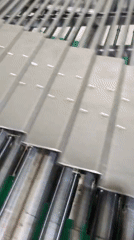 Manufacturing facility processes metal plates on conveyor system