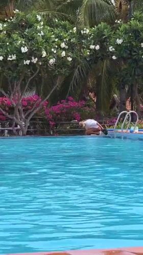 Person jumps into swimming pool in Vietnam
