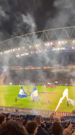 Porto stadium hosts nighttime soccer match with blue lighting spectacle