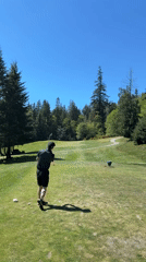 Golfer plays course on Bowen Island during clear evening
