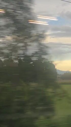 Train passenger films rural Italian countryside near Ferno