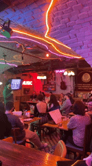 Evening social gathering at neon-lit bar in Saratov