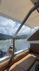 Boat approaches Koh Phangan coastline with twin outboard motors