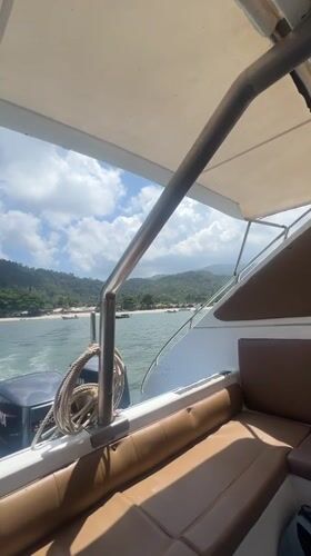 Boat approaches Koh Phangan coastline with twin outboard motors