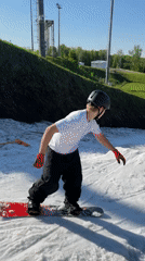 Snowboarders practice tricks on summer snow patches in Krasnoyarsk