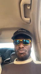 Two men film selfies inside car in Galadimawa