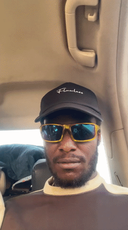 Two men film selfies inside car in Galadimawa
