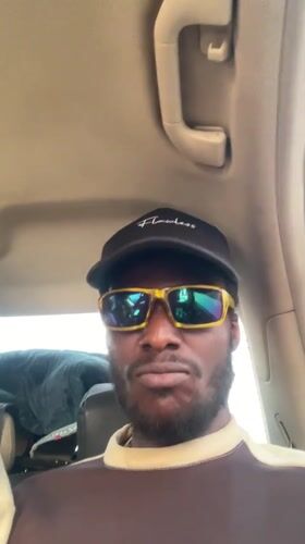 Two men film selfies inside car in Galadimawa
