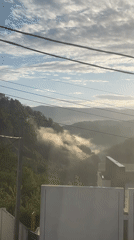 Dawn clears fog over Russian mountain village