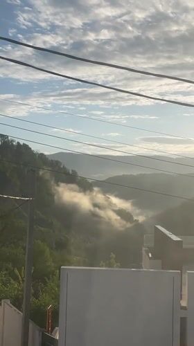 Dawn clears fog over Russian mountain village