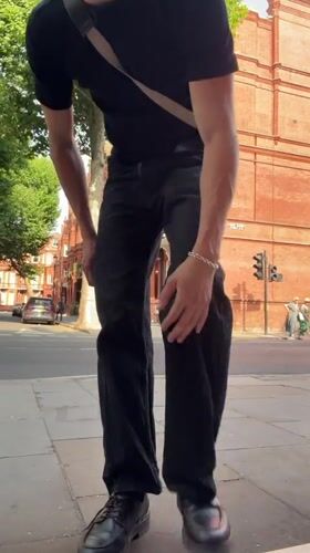 All-black look with crossbody bag on a London sidewalk