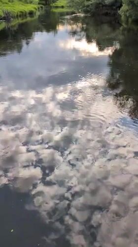 Tourist documents scenic river walk on Russian suspension bridge