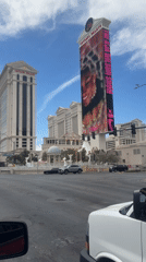 Evening street views capture Caesars Palace, Nike billboard in Paradise