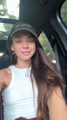 Woman films selfies in parked car on Thailand street
