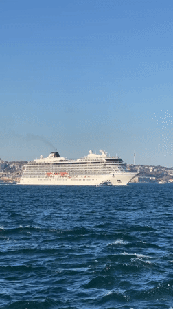 Cruise ship Viking Saturn sails Bosphorus as onlookers gather